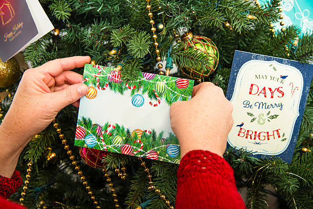 istock Woman Hanging Ornaments On A Tree 518499255