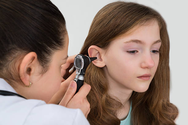 istock Doctor Examining Patient Ear With Otoscope 518499300