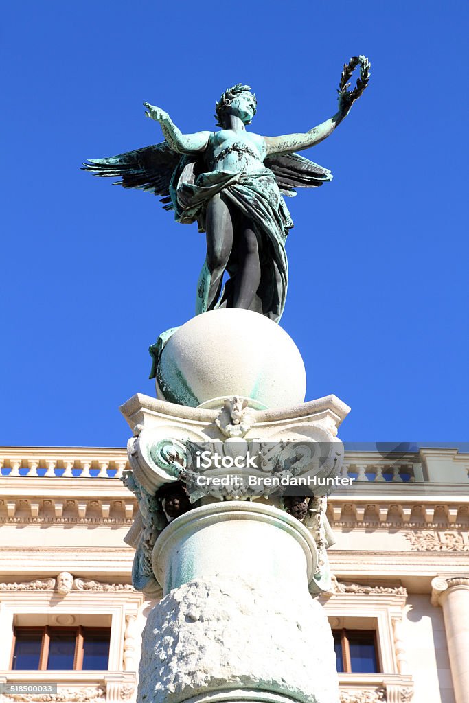 Bronze and Marble A statue atop a sphere in Maria-Theresa-Platz, a large public park in the centre of Vienna. The statue is part of a complex of statues, erected in 1888 by Kaspar Zumbusch, to honor Maria Theresa. Angel Stock Photo