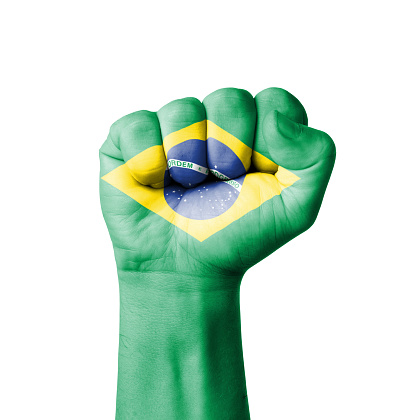 Closed fist and Brazilian flag, September 7th, Brazil's independence day