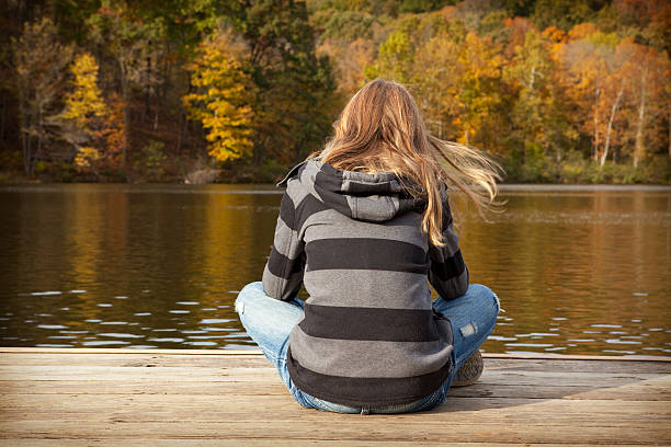 istock Young Girl Sitting On Boat Dock 518501111