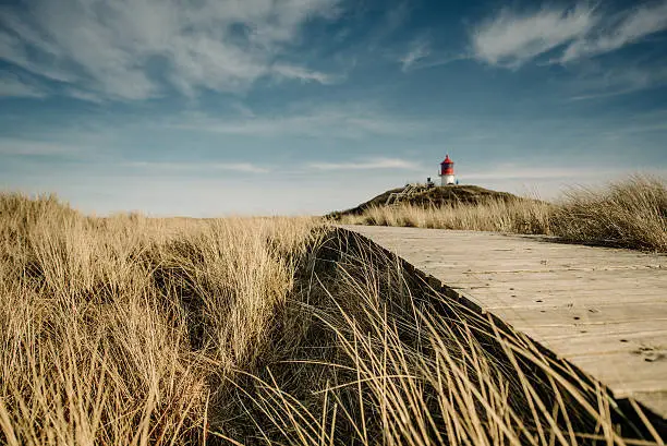 Lighthouse in the dunes with a wooden way - Amrum, Germany