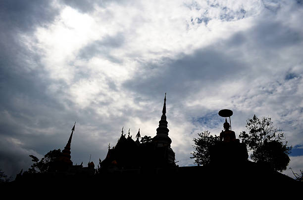 istock Silhouette of Public Pagoda and Buddha Image under Cloudy Sky 518501477