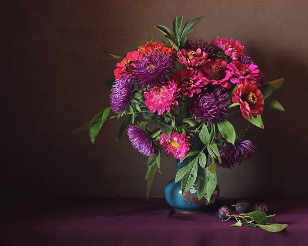 istock Still life with pink and purple asters and plums. 518502304