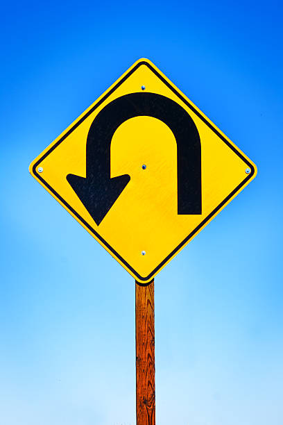 istock Road Sign with Arrow Pointing to Turning Around 518504380