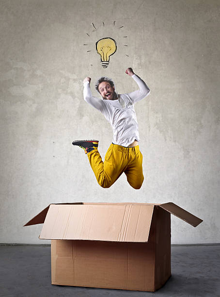 istock Man with an idea jumping out of a box 518505422
