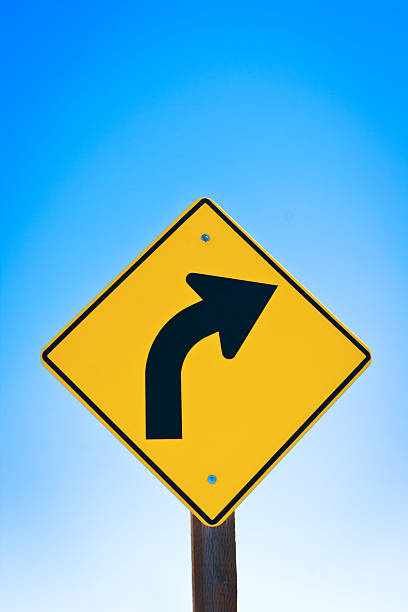 istock Road Sign with Arrow Pointing to Turning Around 518505714