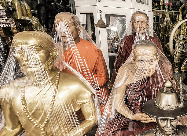 Bangkok, Thailand - February 16, 2016: A souvenir religious shop around the Wat Suthat temple in Bangkok Thailand. Many of this shop have very realistic sculptures of buddhist monks like the ones seen in this pictures  