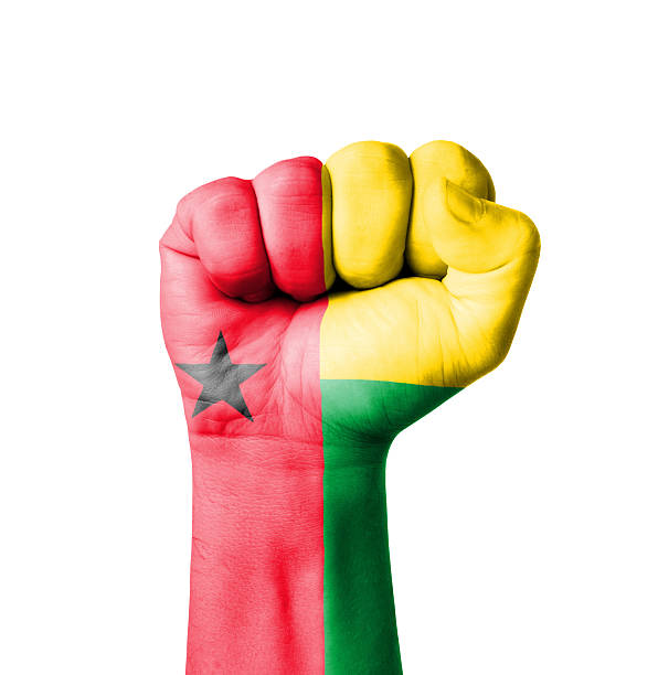 faust gemalt mit flagge von guinea-bissau - guinea bissau flag stock-fotos und bilder