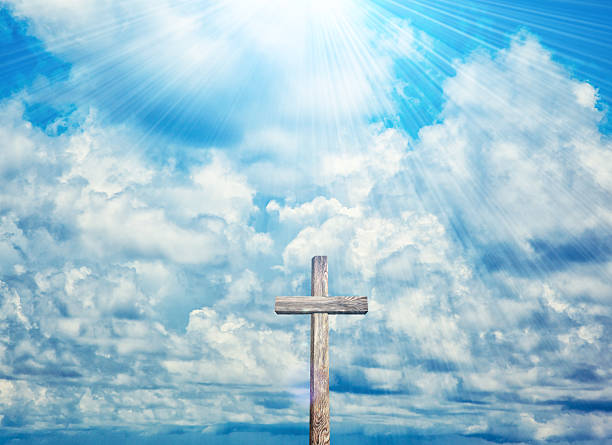 Old wooden cross on blue sky background