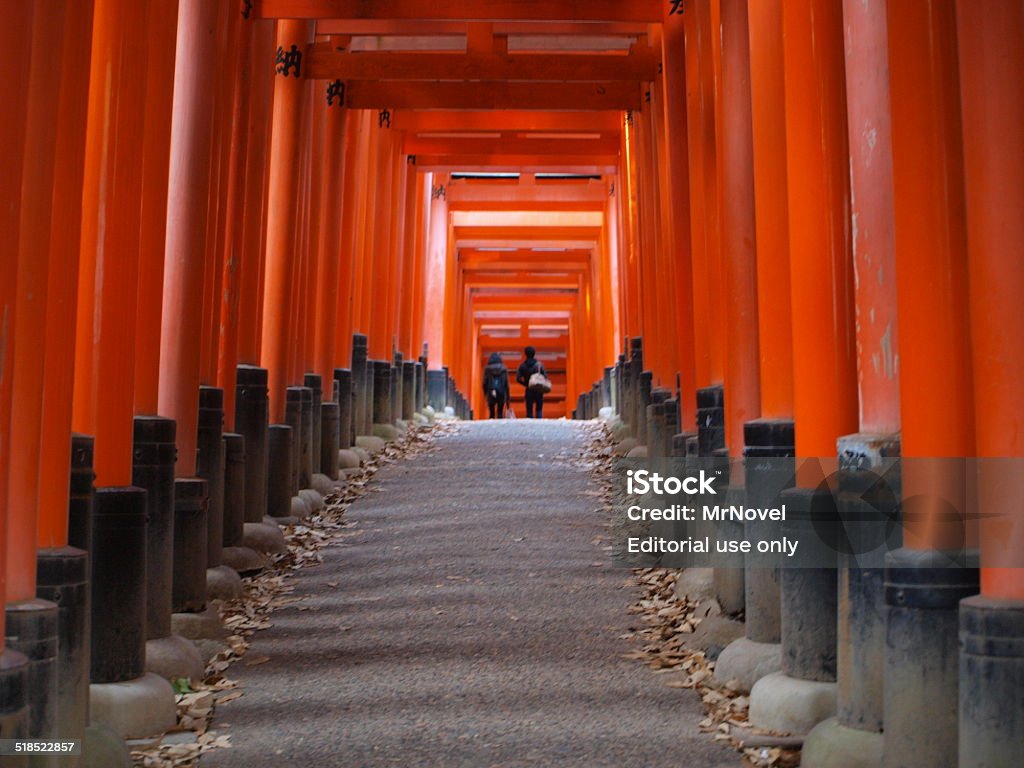 Torii gates of Fushimi Inari shrine, Kyoto, Japan Kyoto, Japan - December 7, 2012: Unidentified people walk in to tunnel of Torii gates at Fushimi Inari shrine, Kyoto - Japan. Shrine Stock Photo