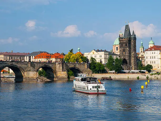 Charles Bridge and Vltava River with steamboat in Prague, Czech republic