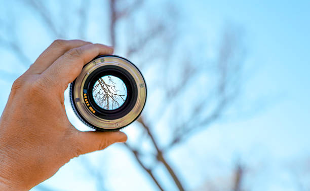 istock Photographer holding up lens 518523838