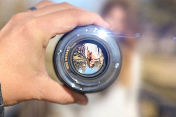Woman on bridge looking through lens