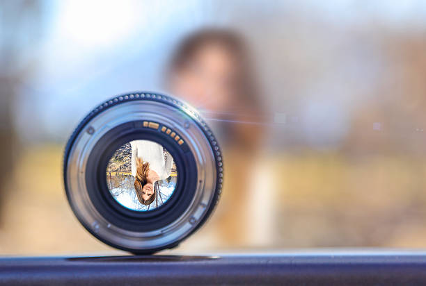 istock Woman on bridge looking through lens 518523894