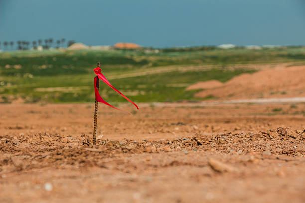 istock Metal survey peg with red flag on construction site 518524534