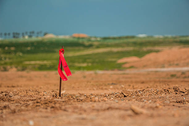 istock Metal survey peg with red flag on construction site 518524580