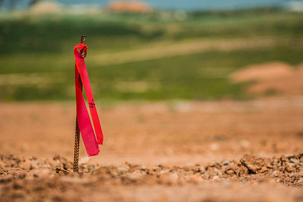 istock Metal survey peg with red flag on construction site 518524624