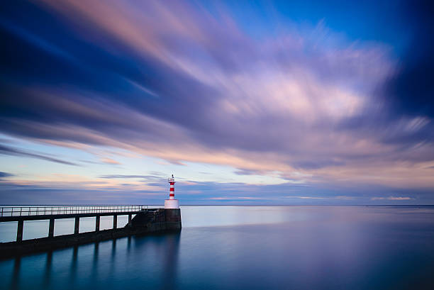 istock Amble pier and lighthouse at sunset long exposure 518524654