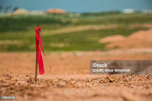 Metal Survey Peg With Red Flag On Construction Site Stock Photo - Download Image Now