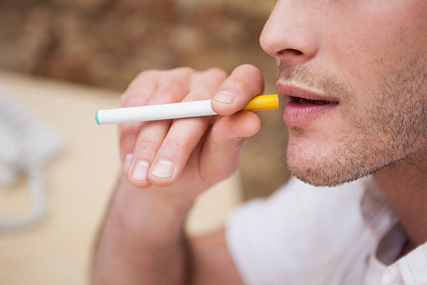 istock Businessman smoking an electronic cigarette 518524899