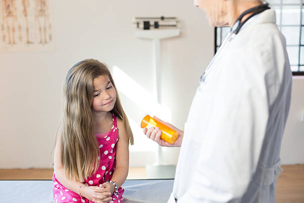 istock Hispanic Girl's Pediatrician Visit, Medication 518525658