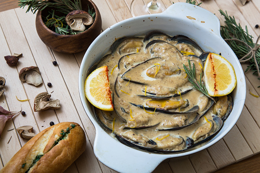 delicious baked mussles with cream sauce and mushrooms and rosemary.