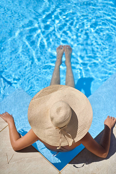 istock Young beautiful woman relaxing in swimming pool 518526196