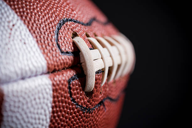 istock Leather American Football on Black background 518526308