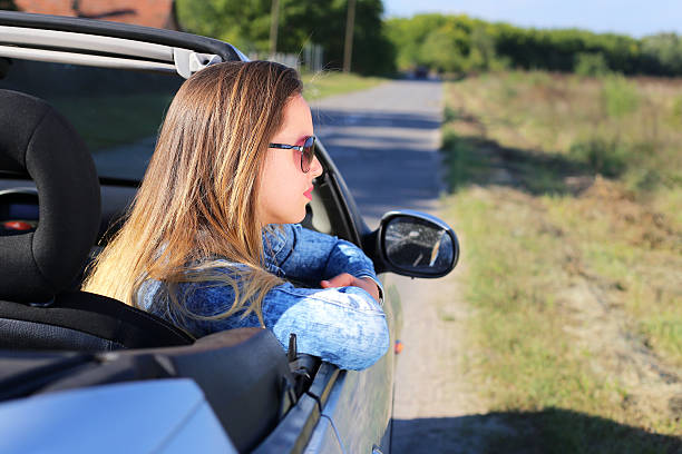 istock Young woman looking from the car 518526614