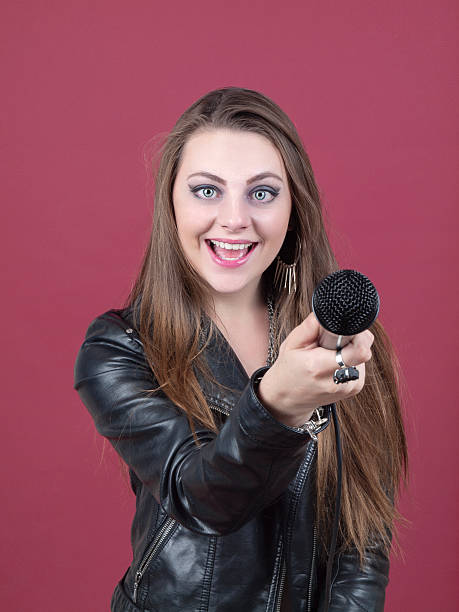 Pretty young woman with Microphone stock photo