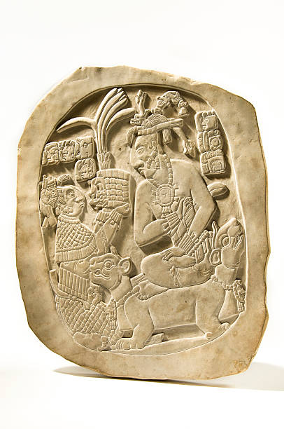 Mayan Stele Isolated Replica of the original pre-Columbian Bas-Relief Stele depicting the last Mayan emperor. This stone depicts the ascension to the throne by king Pakal.  olmec head stock pictures, royalty-free photos & images