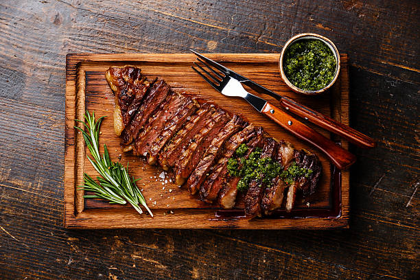 istock Sliced grilled steak with chimichurri sauce 518527614