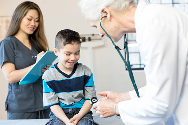 istock Hispanic Boy's Pediatrician Visit, Stethoscope 518528130