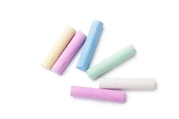 arious colors of chalks on white background.