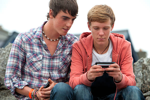 istock Teenage friends using smart phone 518528434