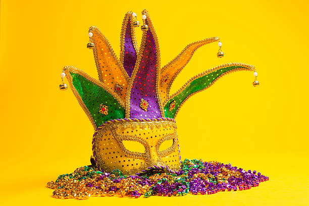 istock Yellow mardi gras jester mask on a yellow background 518529432