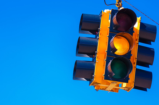 Yellow traffic light with a sky blue background