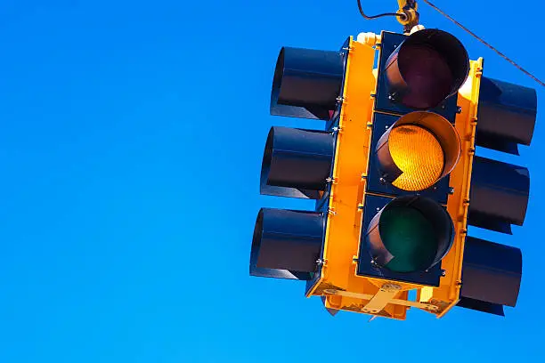 Photo of Yellow traffic light with a sky blue background