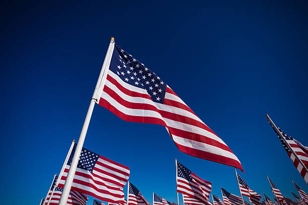 istock Group of American flags with a sky background 518531824