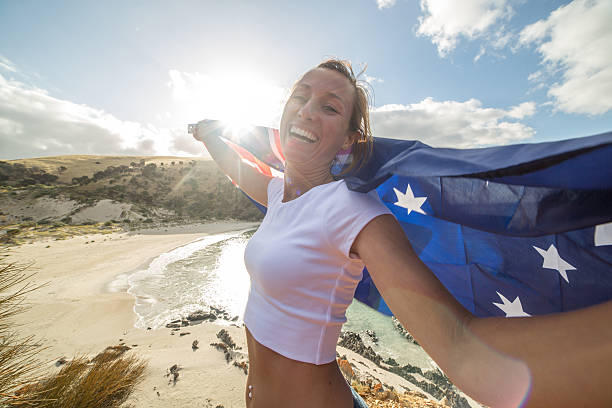 istock Cheering woman on beach holding Australian's flag 518531942