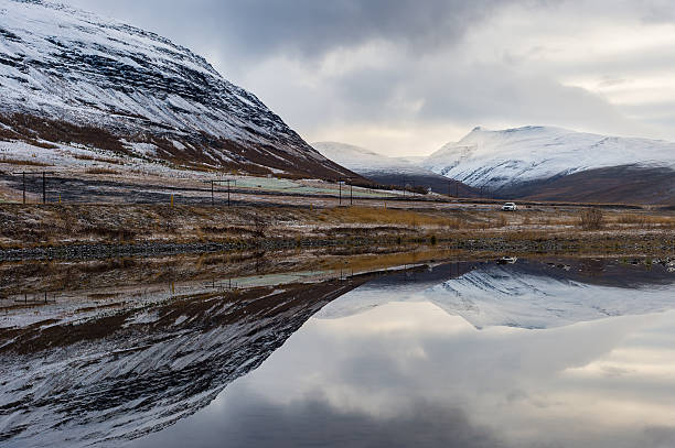 istock Reflection of snow mountain range in ice sheet lake 518533584
