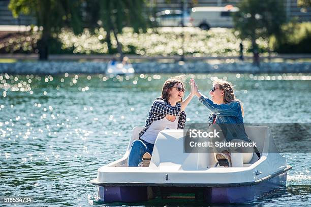 Teenage Girls On A Paddle Boat Stock Photo - Download Image Now - Pedal Boat, Denim, Plaid