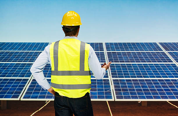 istock Rear view of solar worker pointing away 518535506