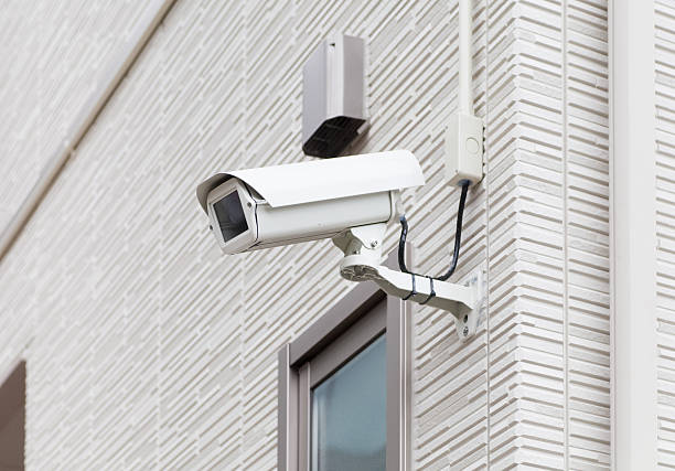 istock Video camera security system on the wall of the building 518536686