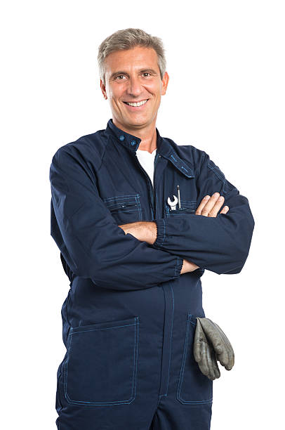 Happy Mature Mechanic Portrait Of Confident Mature Mechanic In Overalls With Arm Crossed Looking At Camera Isolated On White Background repairman stock pictures, royalty-free photos & images