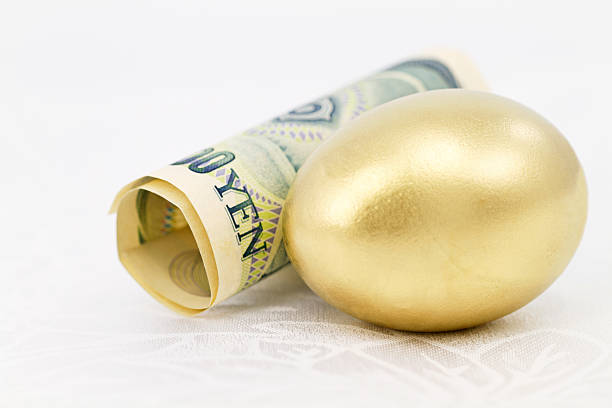 istock Yen and Gold Nest Egg on White Damask 518547127