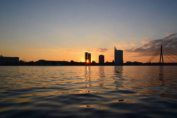 istock Sunset at quay - sun ray through building 518547205