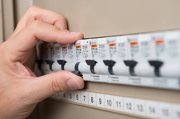 Electrician Testing The Switchboard Closeup Of Person's Hand Repair The Switchboard electrical fuse stock pictures, royalty-free photos & images