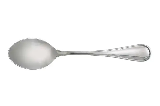 Photo of dessert spoon isolated on white background